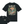 A black short-sleeve graphic T-shirt shown from the back, with a large illustrated mountain landscape print and the words “Walk on The Wild Side” in cream. A smaller inset at lower left shows the front chest print reading “Stoked & Stoked.