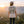 Person wearing a t-shirt with 'Offline on the Road' design, standing in a mountainous landscape at sunset.